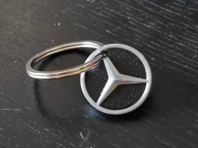 Mercedes-Benz key ring pendant featuring a star emblem   