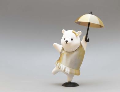 Cute figure of bear girl dancing with umbrella
