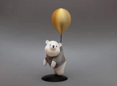 Cute figure of bear flying on balloon