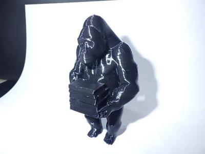 A Gorilla carrying a stack of books.   