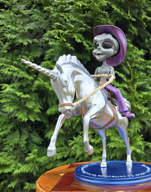 Shirtless Alien Cowboy Riding a Silver Unicorn