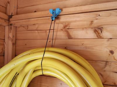 Wall mount for hose and cable