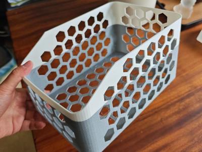 A large, hollow storage box or basket, designed for material efficiency