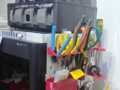 You can hang a pegboard on the hooks on the AMS