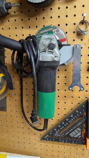 Pegboard holder for Angle Grinder and key   
