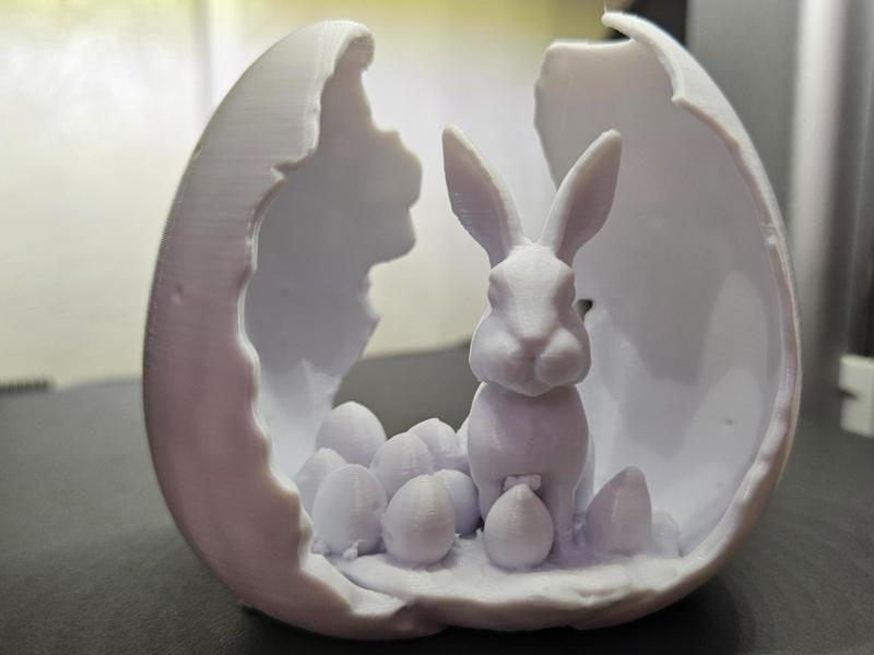 Broken Easter egg with bunny and eggs