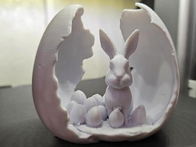 Broken Easter egg with bunny and eggs