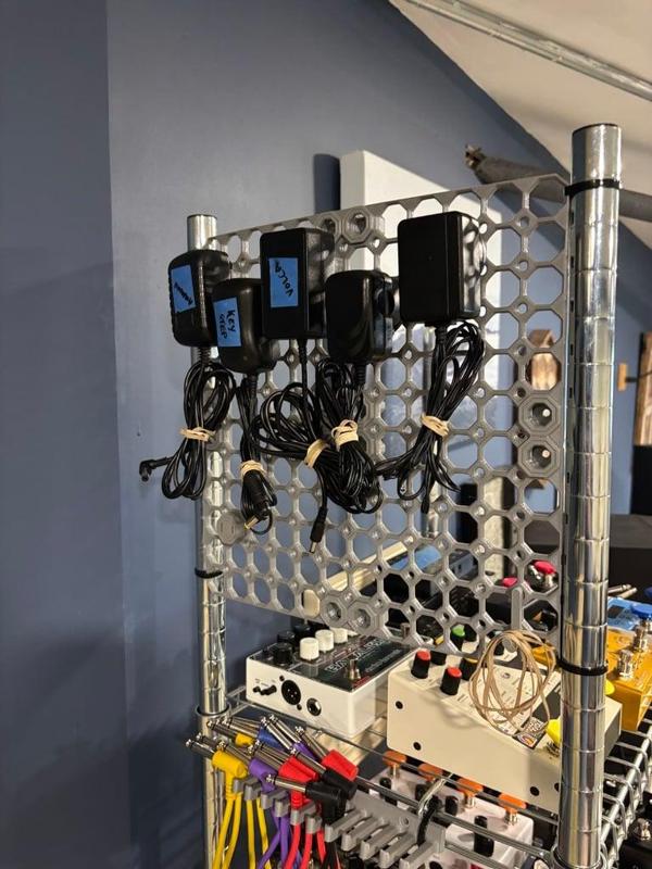 Multiboard Bolt with outlet slots for wall wart storage