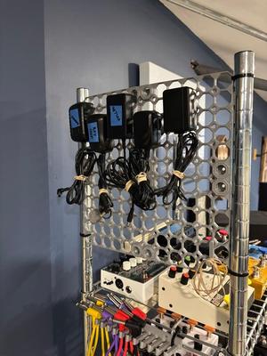 Multiboard Bolt with outlet slots for wall wart storage