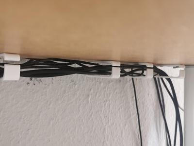 Cable holder under desk. Cable organizer