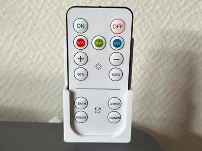 Wall-mounted remote control holder